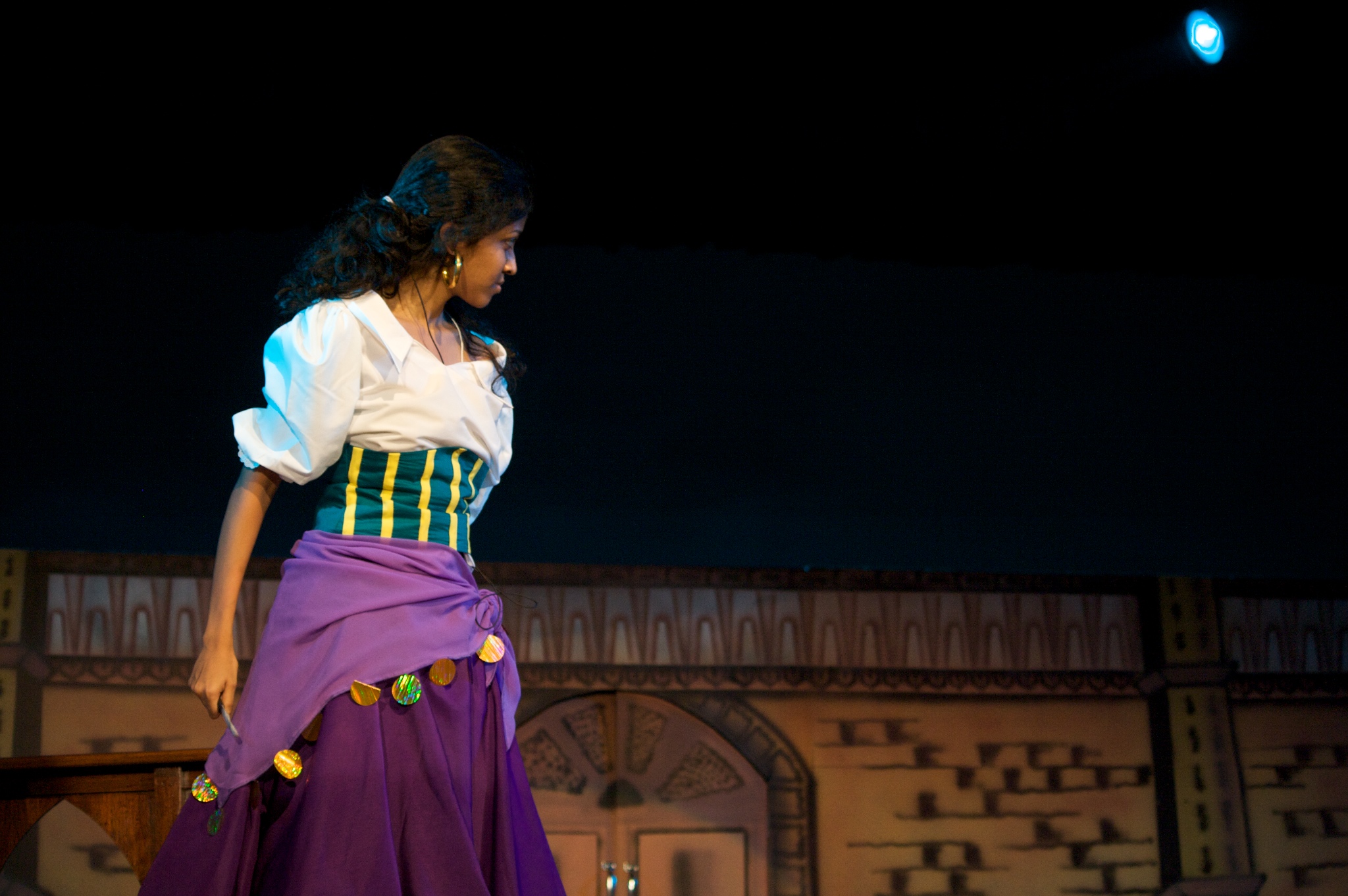 a woman is on stage dressed in renaissance clothing