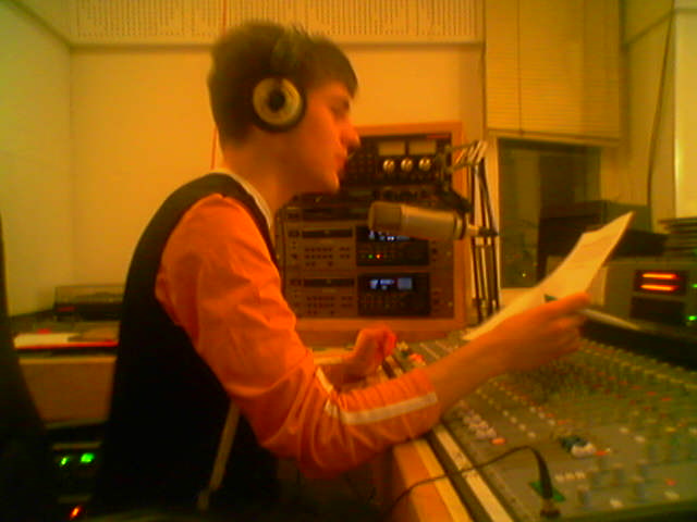 a man is reading a paper while using a mixing studio
