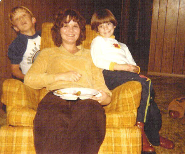 an old po of two boys and a woman on a couch