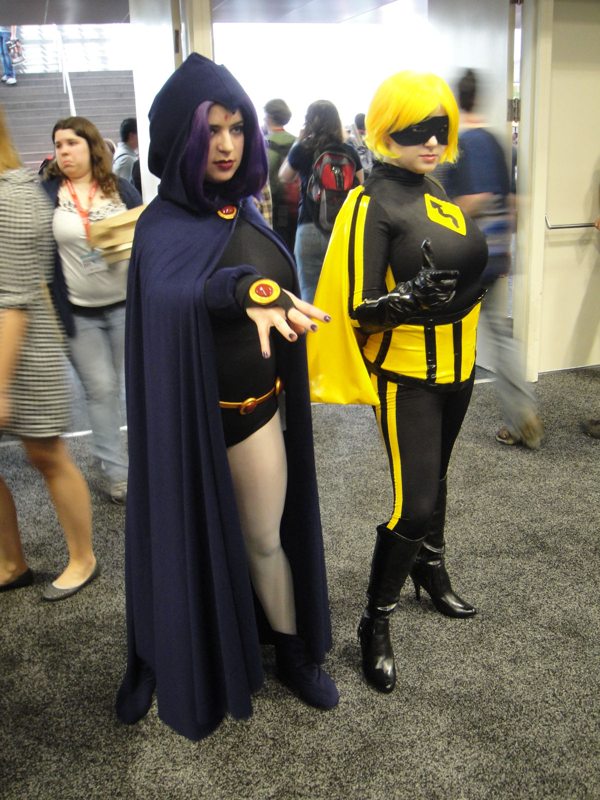 two women are dressed up as super - heros