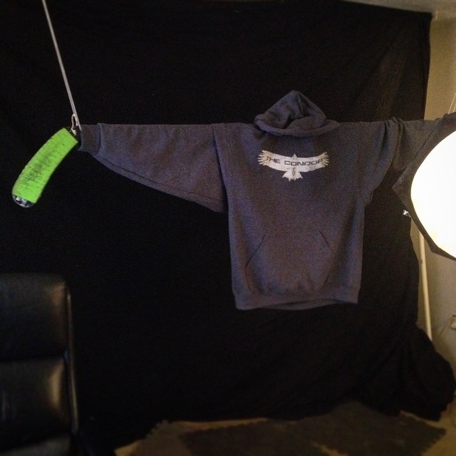 a little 's shirt hangs from a clothesline