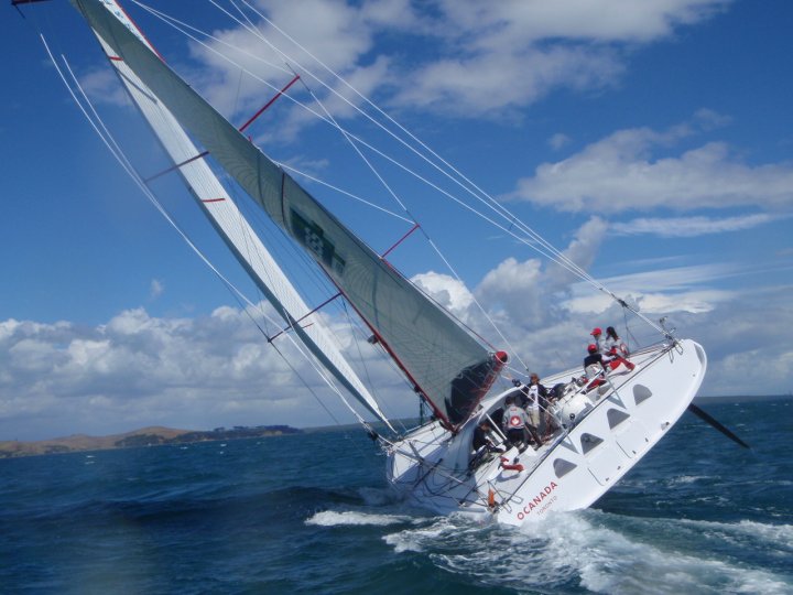 a sailboat is in the ocean with several people on it