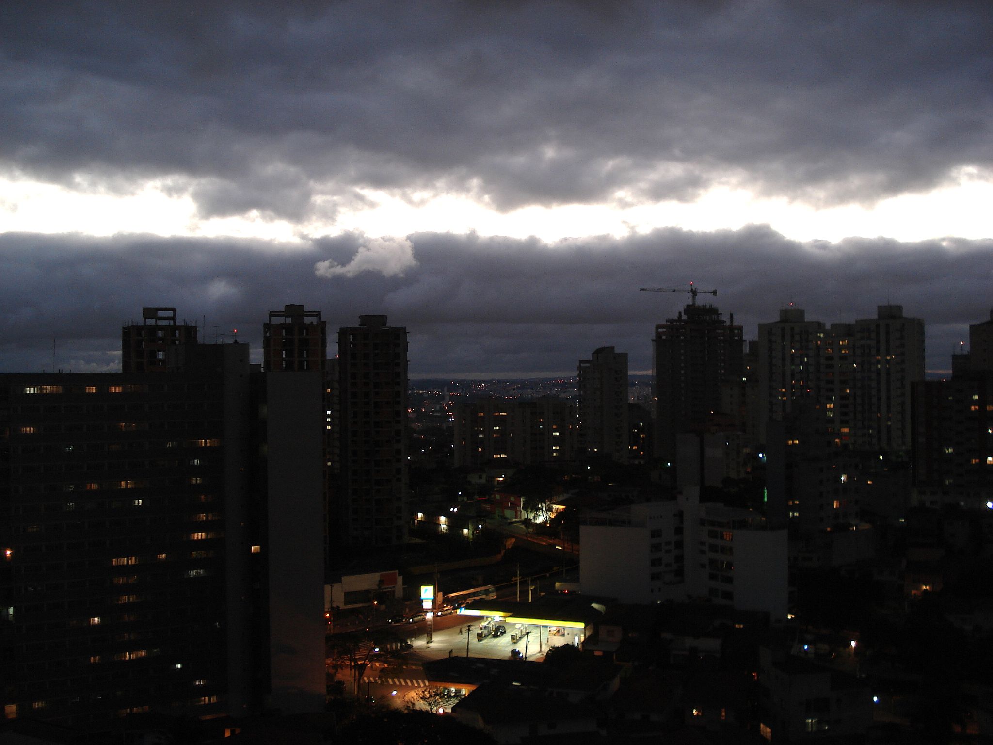 a dark cityscape filled with lights and clouds