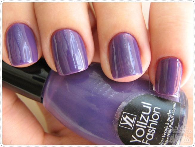 a hand with purple nail polish and an elegant purple nail polish