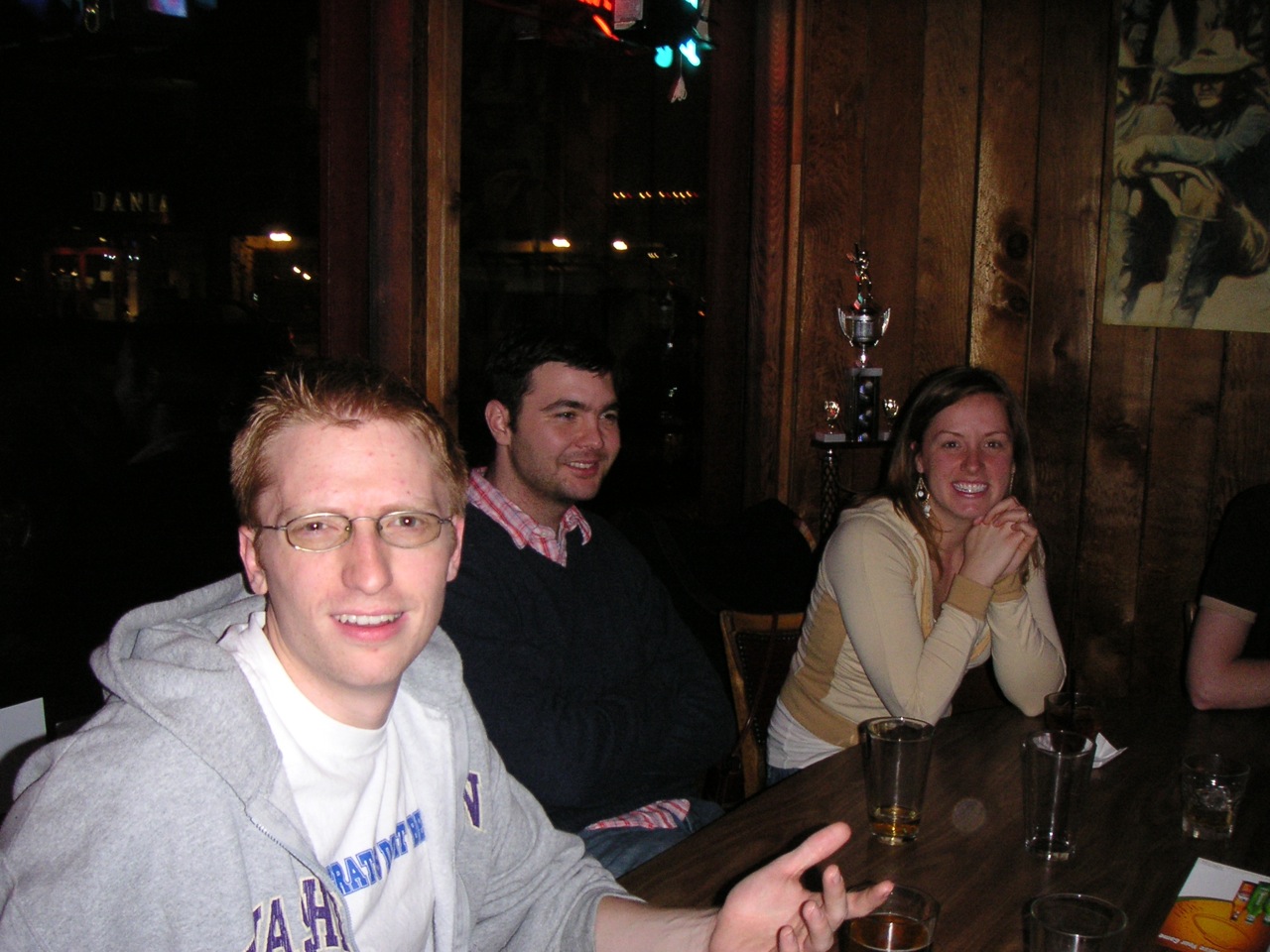 group of people sitting at a table with drinks