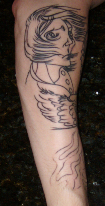 the bottom of a person's leg with a tattoo of a woman