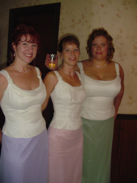 three women wearing dresses are posing for a po