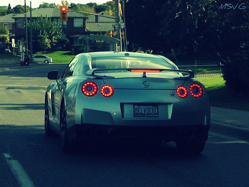 the rear lights of a car on the road