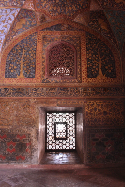 an intricate wall with decorative windows and paintings