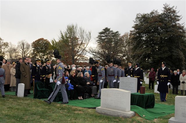 the military and military personnel are gathered around a grave