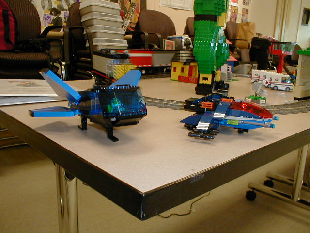 several small toy helicopters set up on a table