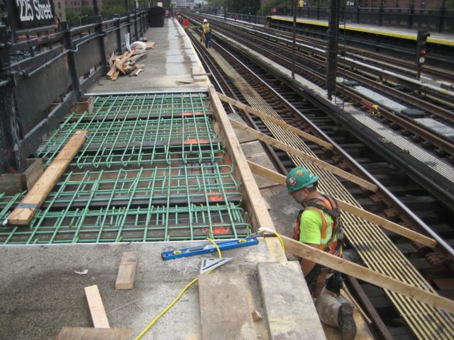 a man working on some kind of construction at the rail station