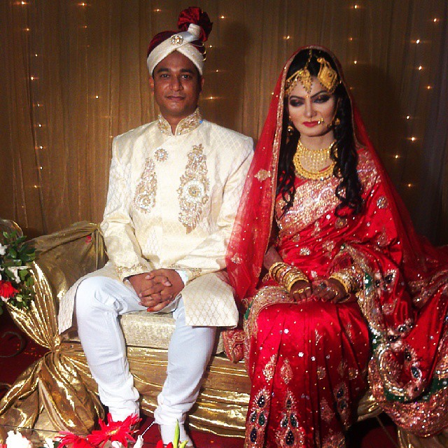 a man and woman dressed in indian garb sitting next to each other