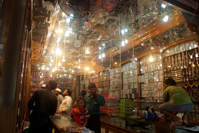 people standing around a glass store in a building