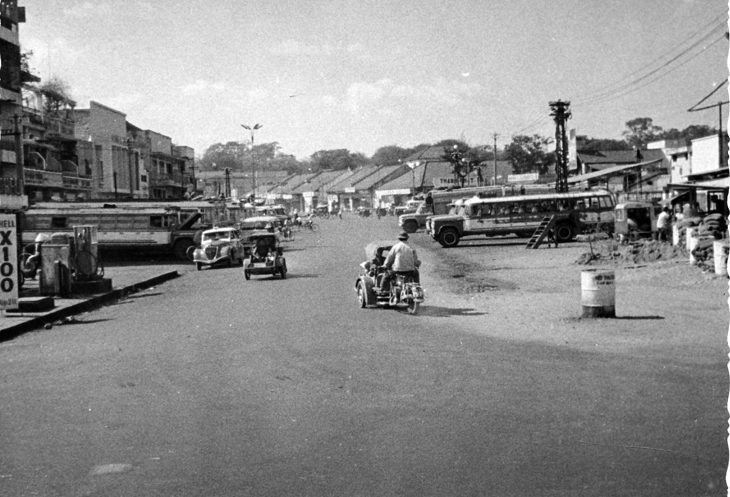 people and cars in an area with buildings