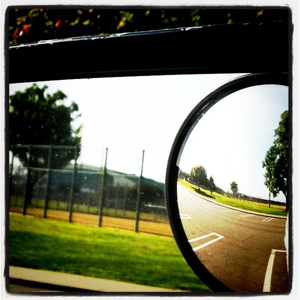 a round mirror on the window of a vehicle