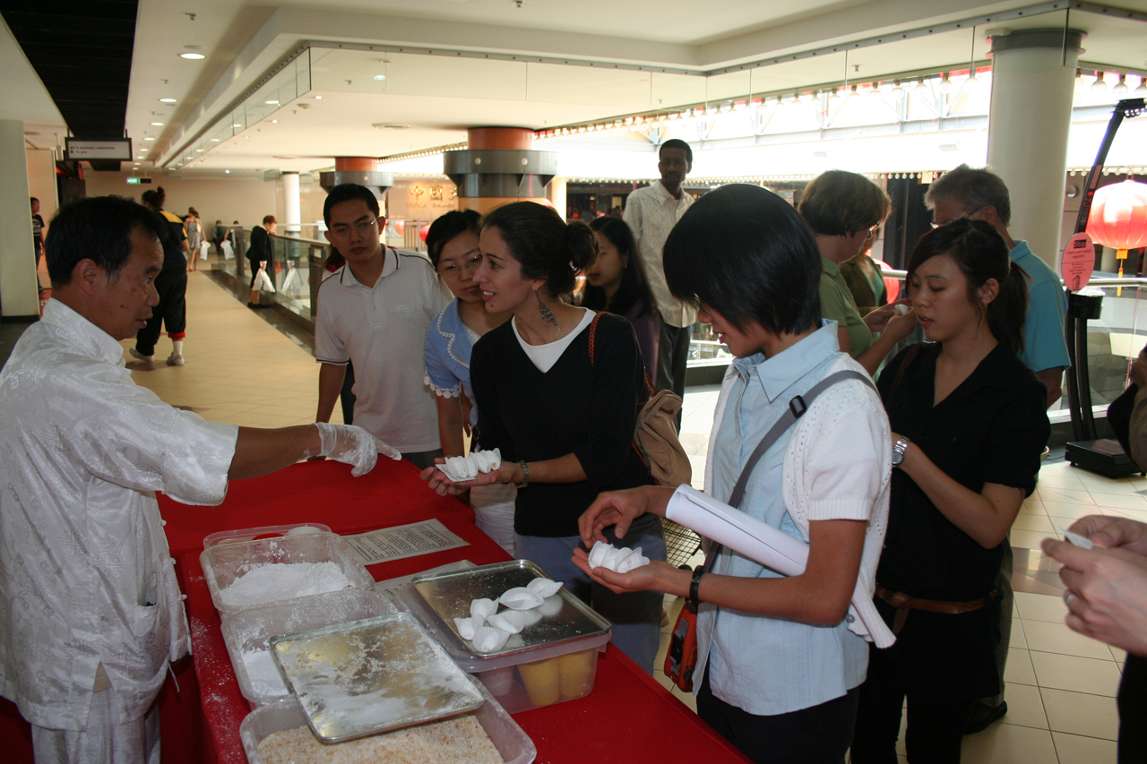 people line up to buy some cake