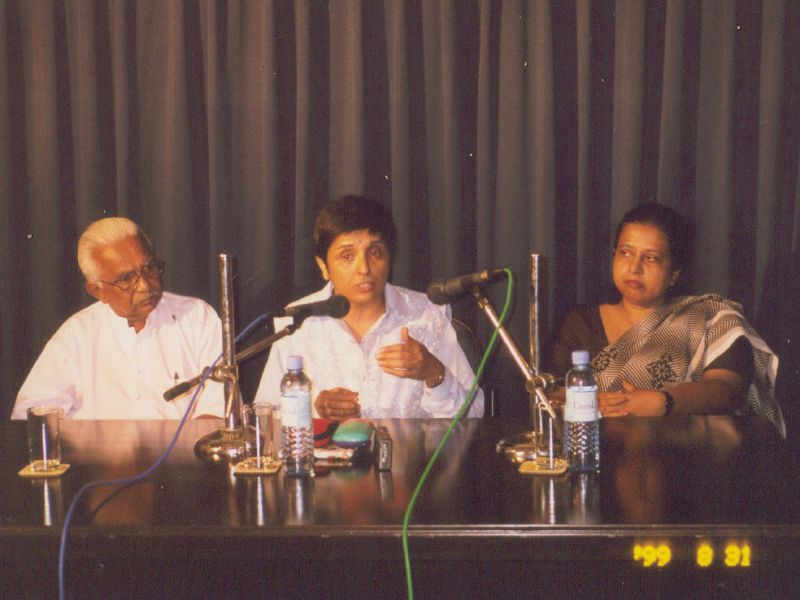 several people sitting at a table with microphones