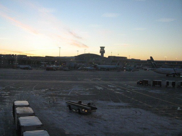 a plane at an airport in the sunset