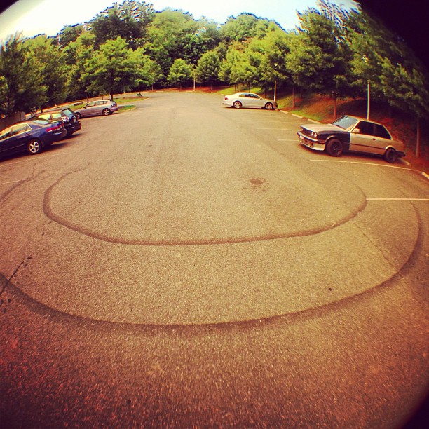 view of several cars parked in a spot where one is on the side of the road