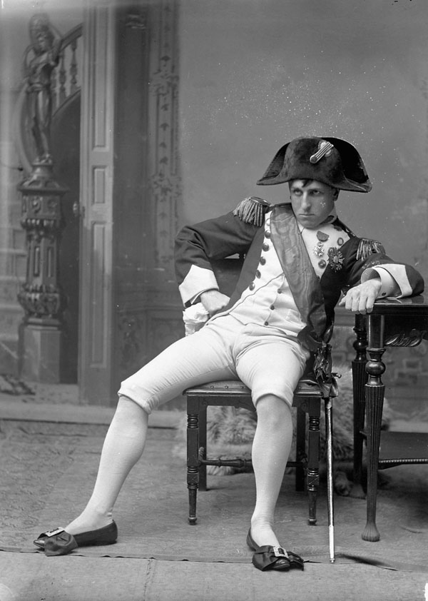 a boy in a pirate's outfit sitting on a chair