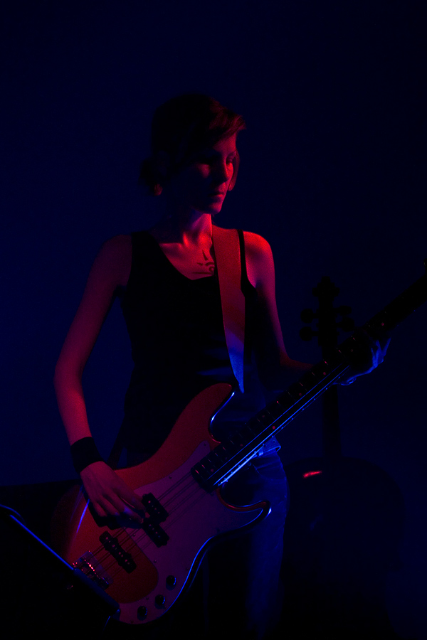 a person with a guitar in a dark room