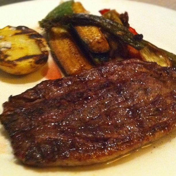 steak on a plate with vegetable, and small potatoes