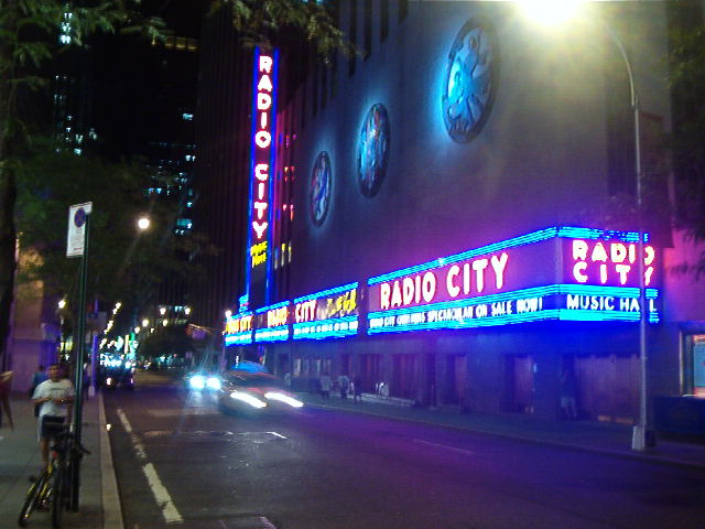 the radio city radio city sign is lit up at night