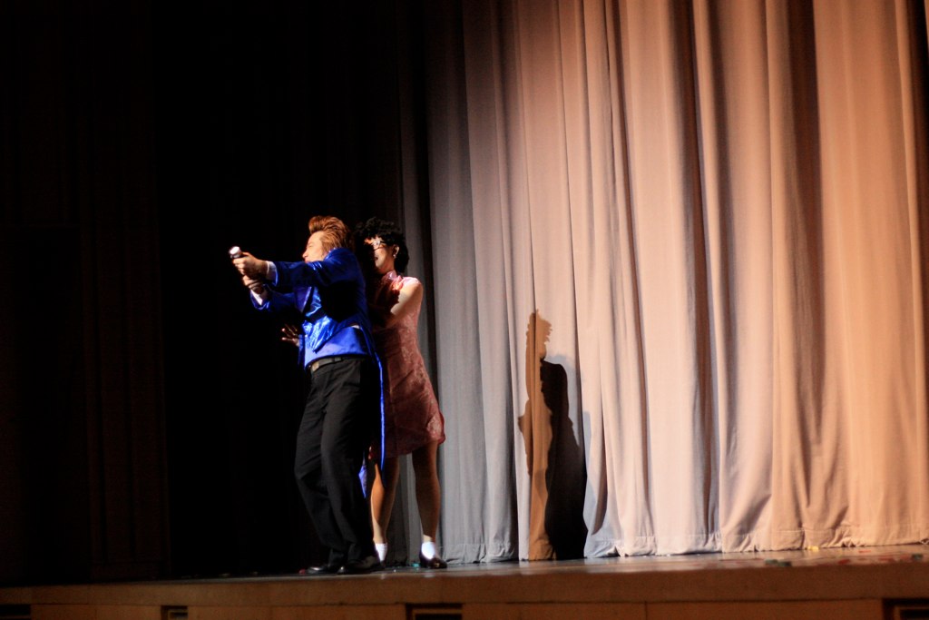 two young people are performing on stage