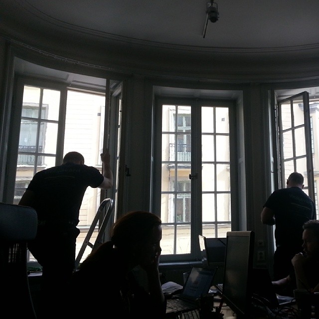 a group of people working on computers in a room