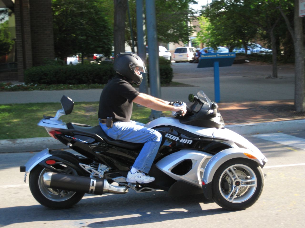 the motorcyclist is wearing a helmet while riding his bike