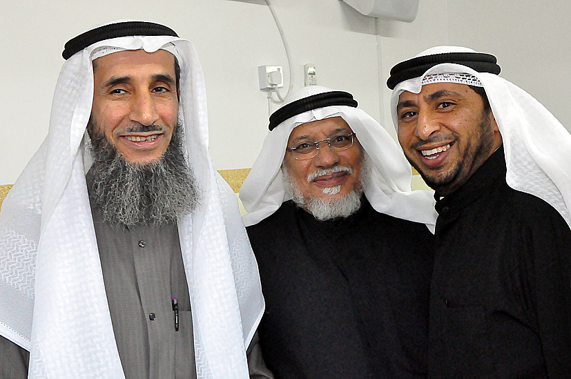 three men with headscarves are standing next to each other