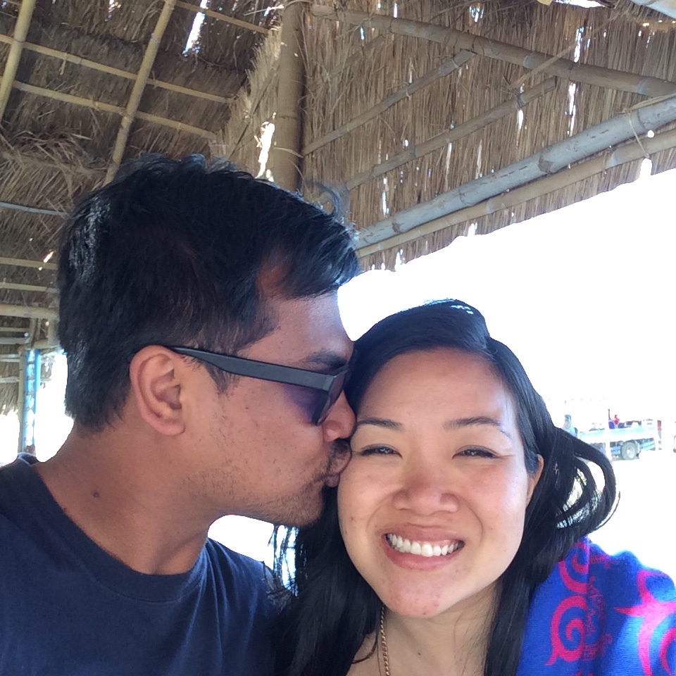 a young man is giving a kiss to a smiling woman