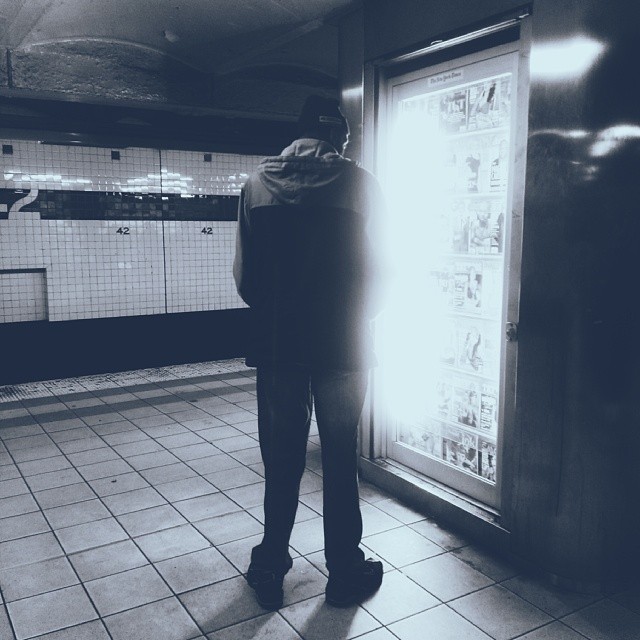 a person looking in an empty subway station