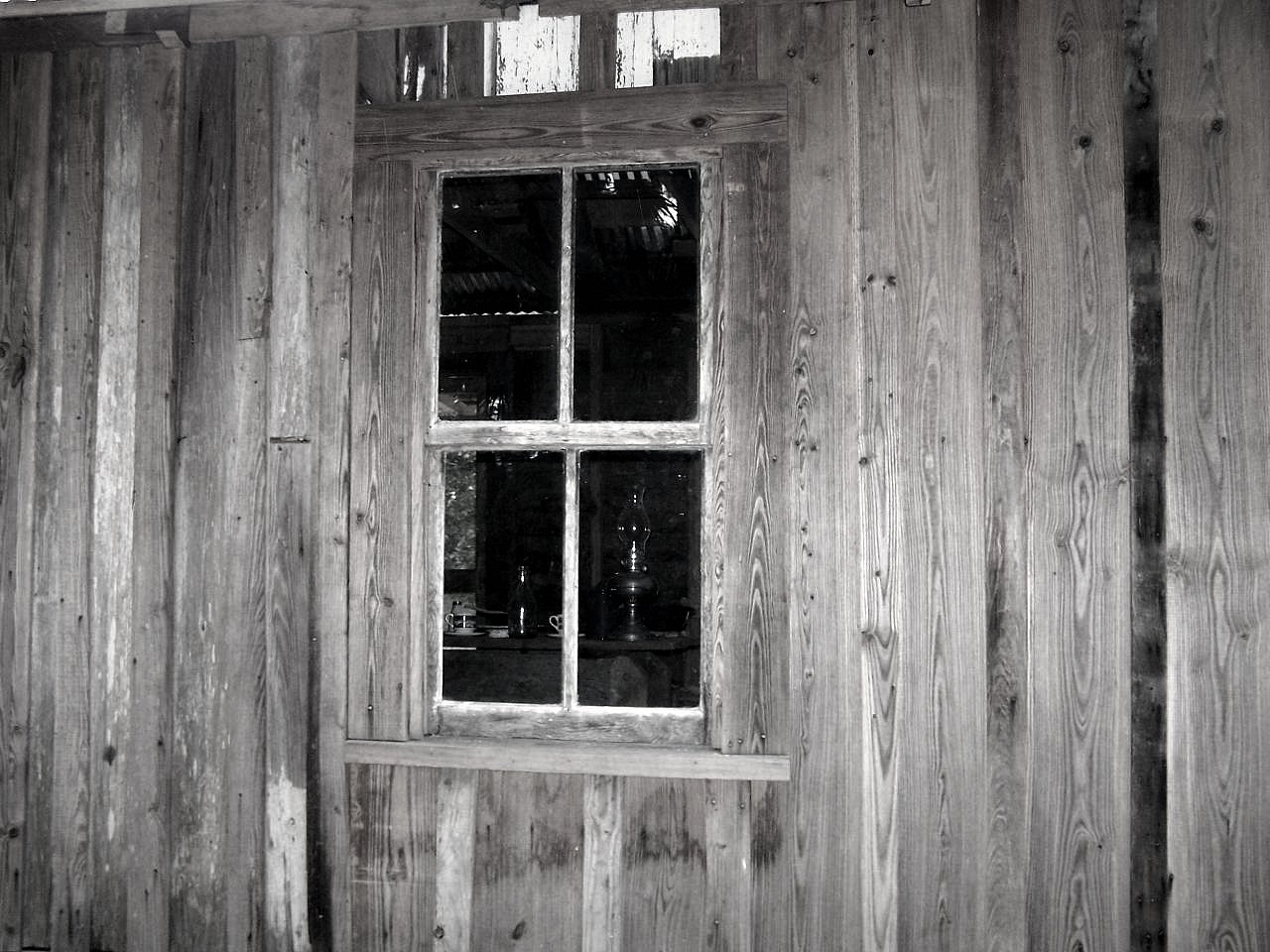 an old wood paneled house with windows