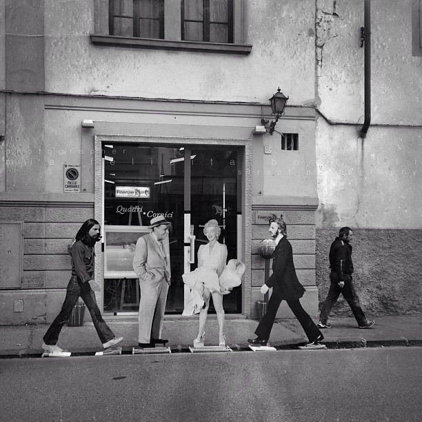 five young women crossing the street in front of an old building