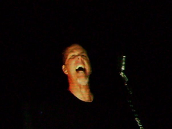 a male is yelling while playing with a bat