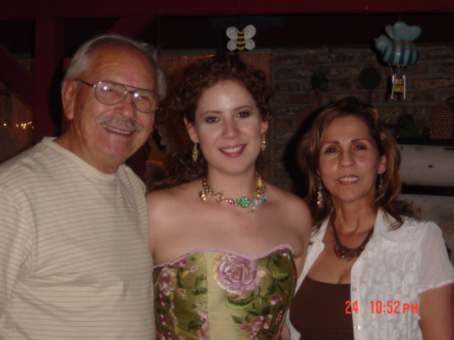 two women are smiling while standing with two older men