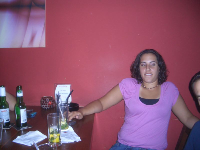 a woman at a table with alcohol bottles