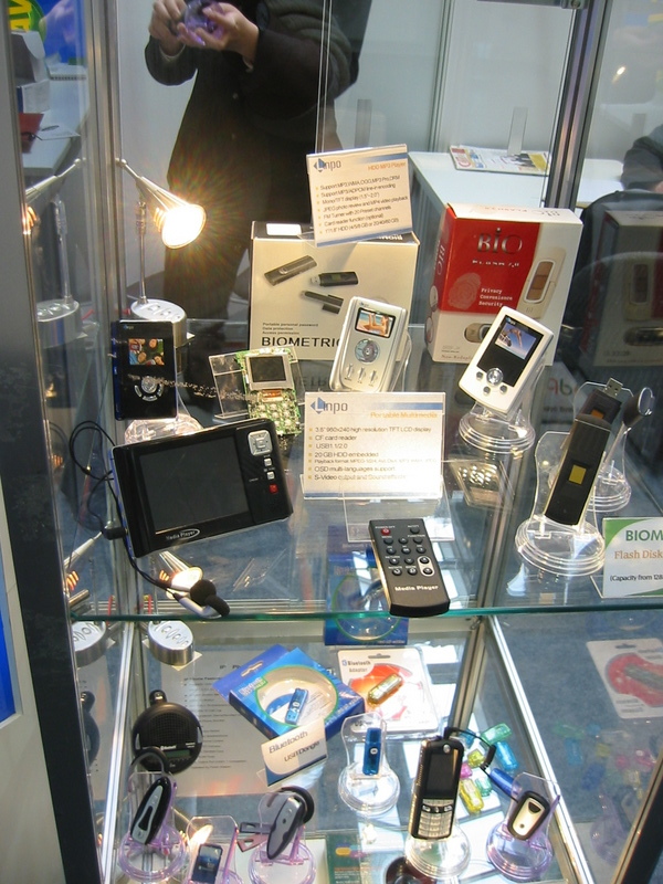 a man talking on a cell phone while looking into a display case