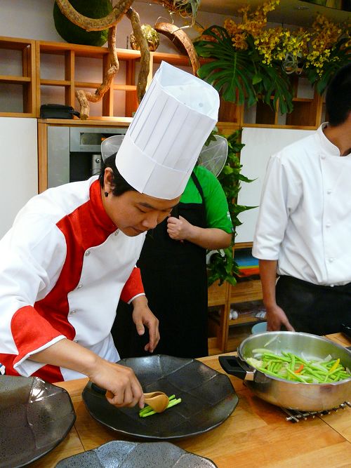 a man in a chef's uniform  food in bowls