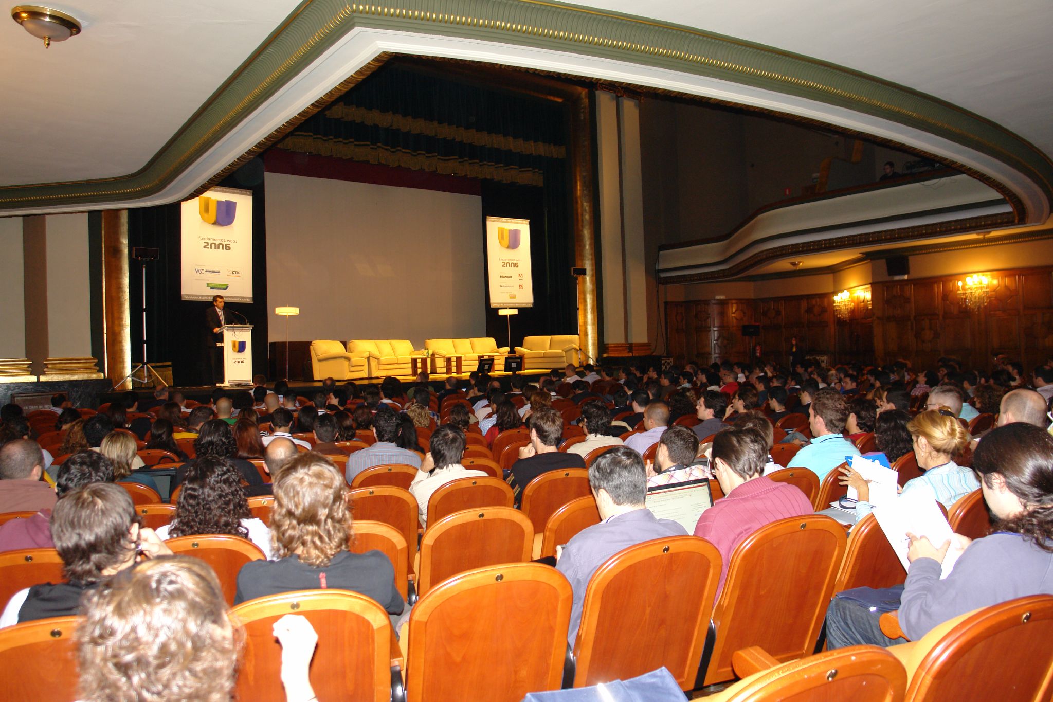 people sit in chairs and watch a presentation