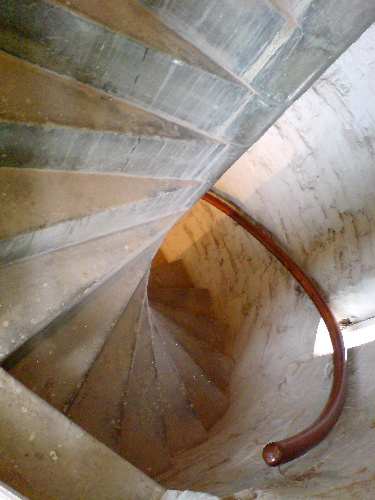 a man rides up a flight of stairs in a cement tunnel