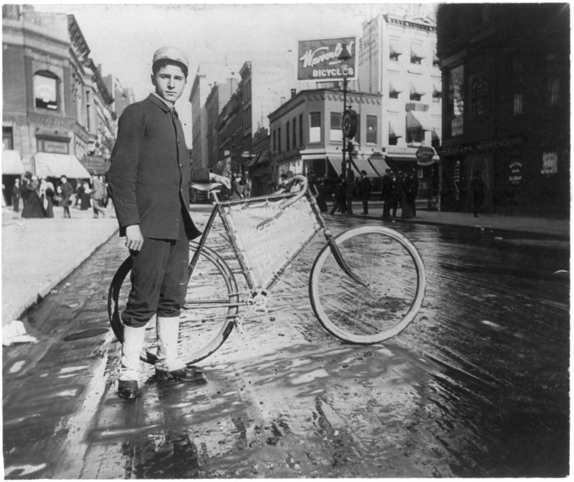 a man standing with his bike in the rain