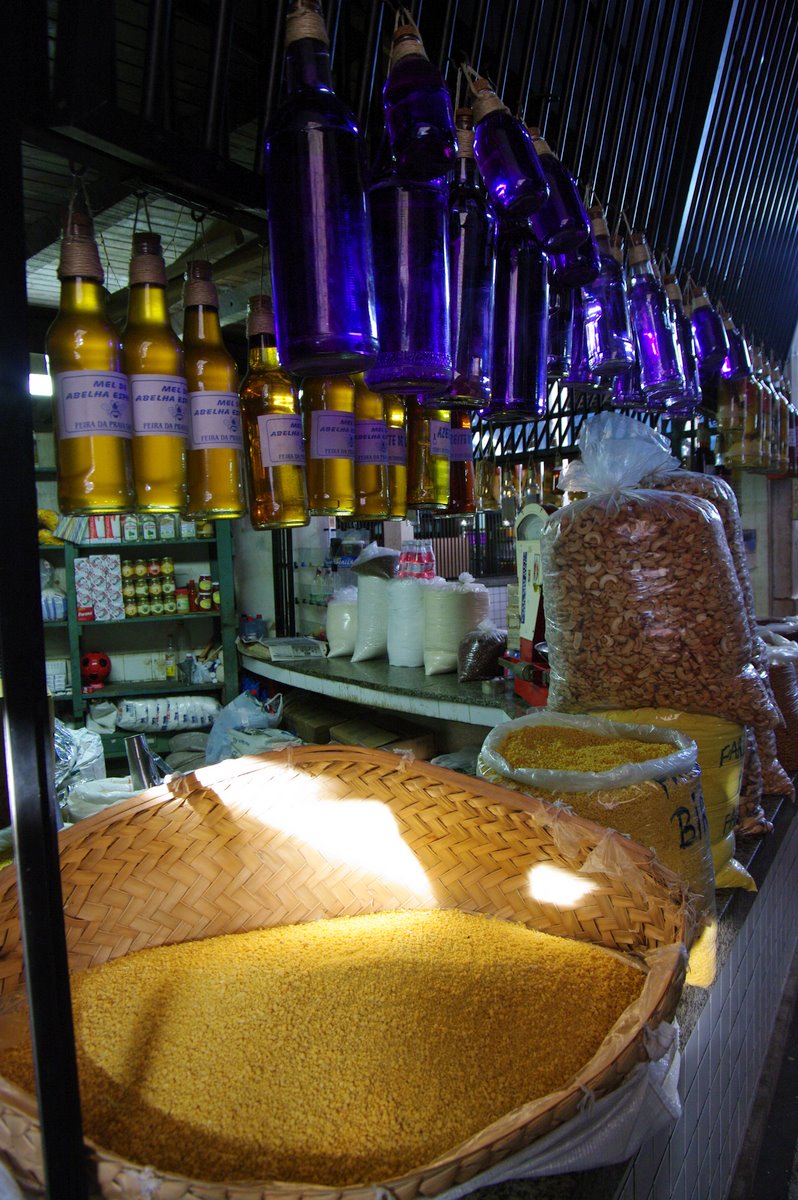 a store filled with lots of food next to bottles