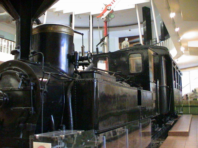a very large black train on display in a building