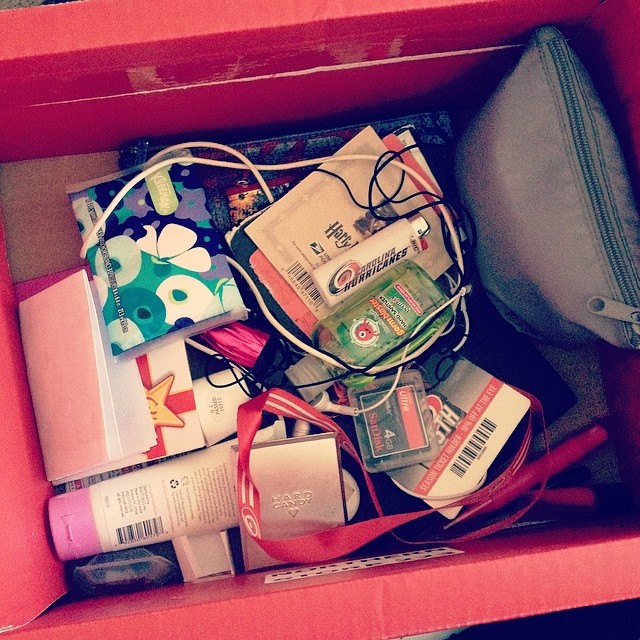 a red box filled with bags and cosmetics