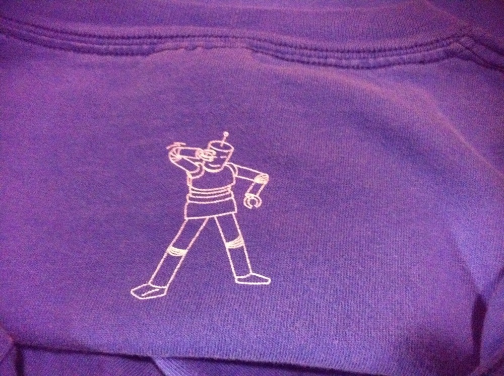 there is a small white line drawing on a purple shirt