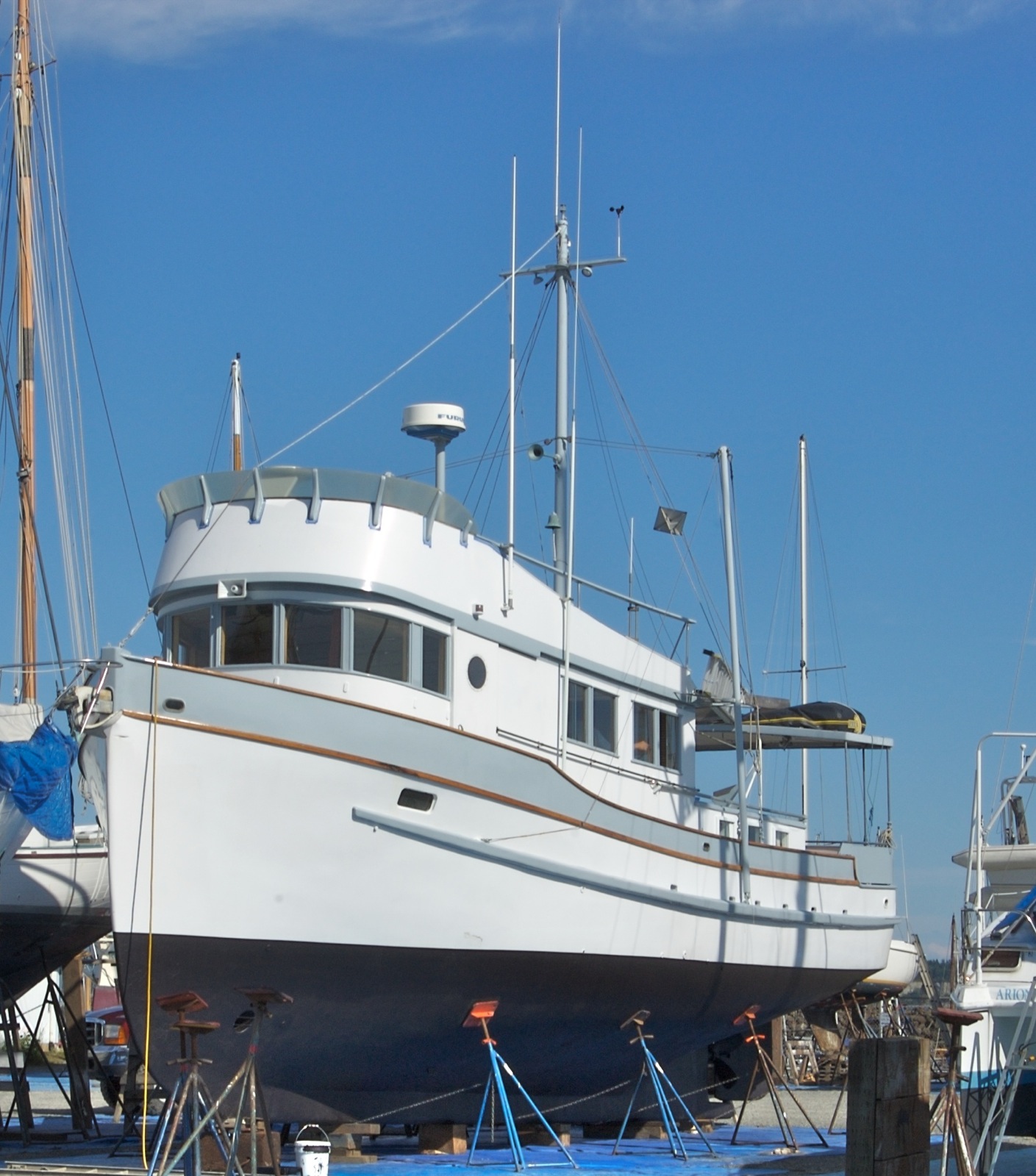 a white ship is tied up in the harbor