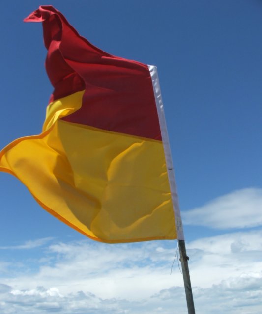 a german and austrian flag on the beach